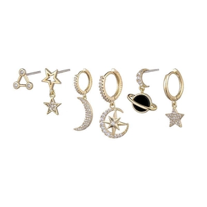 Detailed close-up of six gold star and moon stud earrings with sparkling cubic zirconia