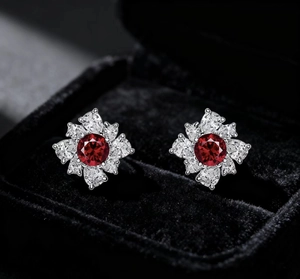 Macro shot of French vintage flower earrings with red crystal and sparkling white stones