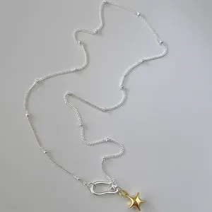 Gold star pendant necklace with mixed silver bead chain and front toggle closure