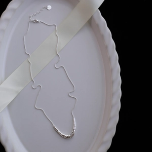 Macro detail showing the S925 silver hallmark and hammered texture on the horn pendant