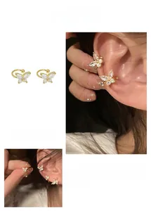 Macro detail of gold-plated butterfly ear cuff with micro-set cubic zirconia stones