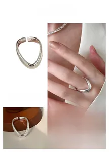 Detailed views of silver V-shaped wave ring with minimalist adjustable open band design