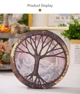 Detail of Shaman drum featuring Tree of Life pattern with furry mallet in retro setting