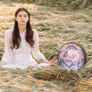 Artistic Shaman drum with purple dragon illustration for meditation in field