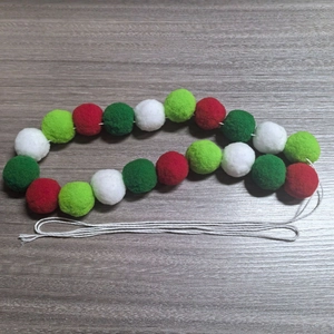 Detail of 2m Christmas wool felt ball garland with red, white, and green hanging ornaments