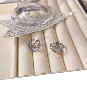 Elegant silver double-layer hoop earrings with cubic zirconia inlay on a jewelry tray