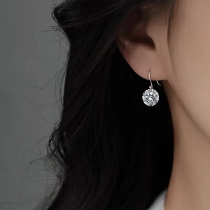 Boucles d'oreilles pendantes en zircone ronde sur mannequin avec crochets argentés épurés