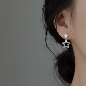 Minimalist S925 silver star earrings with white zircon on a model for elegant look