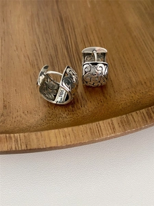 Detailed macro view of S925 sterling silver hoop earrings with hollow filigree cloud patterns