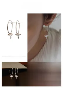 Detailed views of silver mushroom charm hoop earrings with realistic texture
