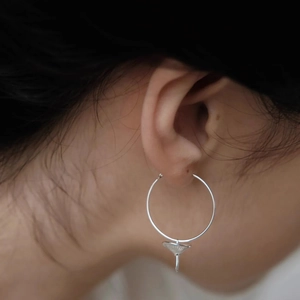Silver mushroom pendant hoop earrings featuring minimalist design and metallic luster