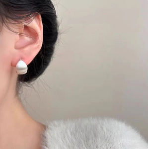 Brushed silver water-drop hoop earrings shown on model for daily minimalist style