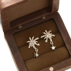 Sparkling starburst earrings with cubic zirconia star pendants in a luxury wooden box
