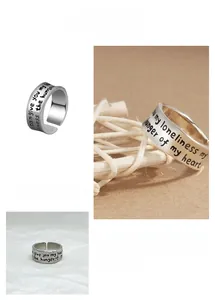 Close-up of vintage silver open ring with engraved English poetry and wavy edges