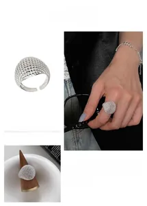 Detailed view of hollow mesh ball ring in S925 sterling silver with open adjustable band