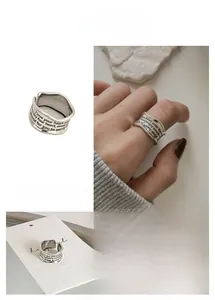 Detailed close-up of S925 sterling silver open ring with twisted wide band and engraved text