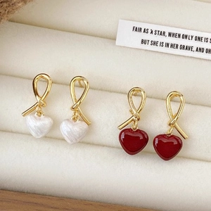 Elegant gold knot heart drop earrings in cream white and deep red glossy enamel finish