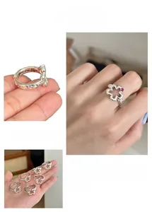 Macro shot of silver flower ring with pink zircon and engraved you are best inner band