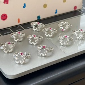 Hollow flower S925 silver ring with pink zircon gemstone in minimalist floral design