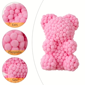 Detail view of pink pompom bear showing soft material texture and side ear design