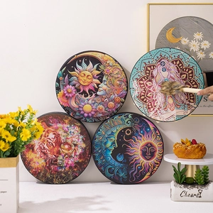 Detailed close-up of shamanic hand drums with sun, moon, and goddess boho artwork patterns