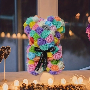 Close-up of a colorful rose bear with Just for you ribbon and romantic lights