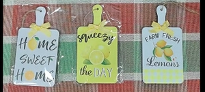 Close-up of lemon wooden signs with yellow bows and hemp ropes for kitchen decor