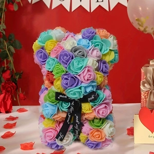 Colorful PE rose flower bear with Just For You ribbon on a festive red background
