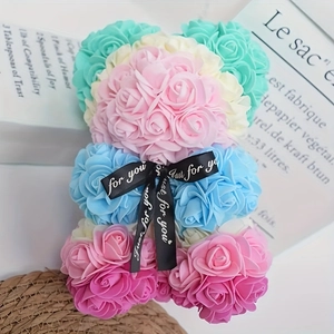 Detail of multi-colored rose bear with Just for you ribbon on a rustic straw base