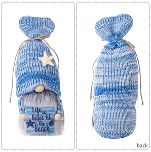Detail view of beach gnome showing front and back with ocean star and sea shells