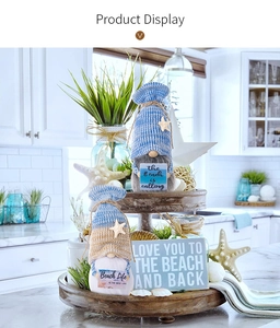 Detail of beach gnomes in nautical tier tray with seashells and beach life signs