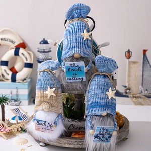 Close-up of three blue beach gnomes with nautical star hats and summer slogans