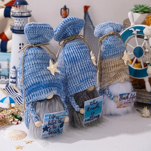 Detailed view of three ocean-themed plush gnomes with nautical accessories and slogans