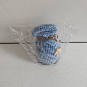 Close-up of blue and white knit drawstring pouch with starfish detail and hemp rope