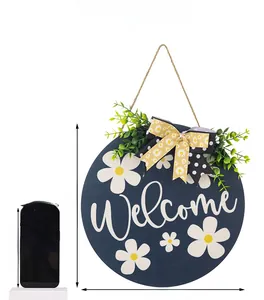 Detail of round welcome door sign with white daisies and double bow for farmhouse porch décor