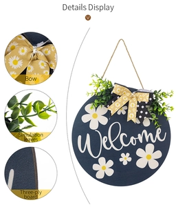 Close-up of rustic bow, faux leaves, and wood texture on a blue welcome door sign