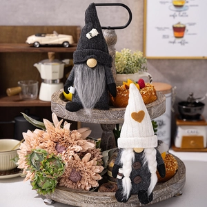 Detail of knit coffee gnomes with bean buttons and coffee cup charms on a wooden tray