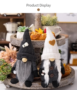 Detailed close-up of coffee gnomes with knitted hats and cups on a wooden tray
