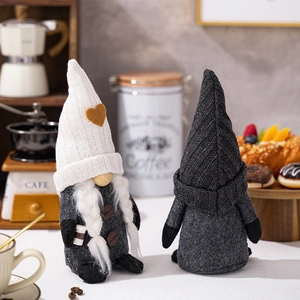 Detail of knitted coffee gnomes with mini cafe cups for cozy kitchen decor