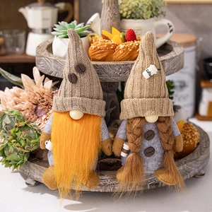 Detail of coffee gnome pair on wooden tray with knitted hats and coffee cup decor