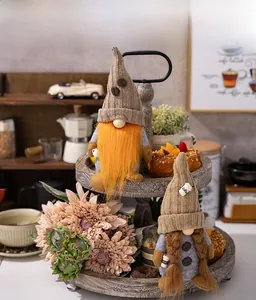 Close-up of handmade coffee gnomes with knitted hats and coffee bean detail on wooden tray