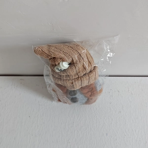 Detailed close-up of a knitted coffee gnome ornament with a cute mini Coffee cup on its hat