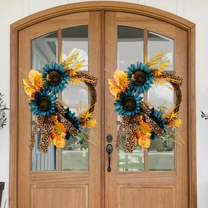 Detail of blue sunflowers, maple leaves, and leopard ribbon on rustic twig wreaths