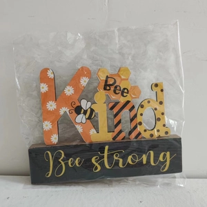 Bee Kind themed wooden table ornament with honeycomb design and daisy floral details