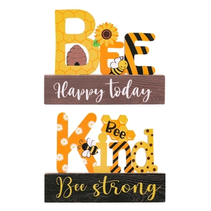 Wooden bee themed tabletop signs with Bee Happy today and Bee Kind strong text decor