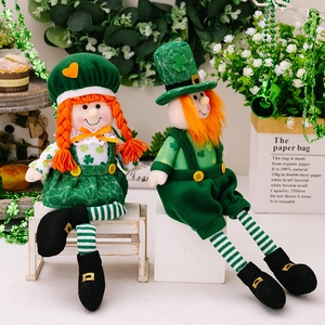 Pair of St. Patrick's Day plush dolls in green hats with clover patterns and striped legs