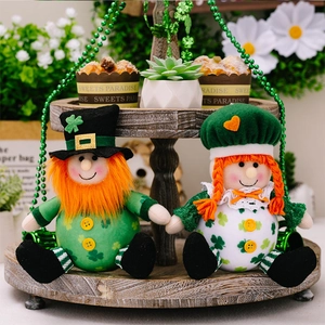 Détail de poupées de la Saint-Patrick avec motifs trèfles sur un plateau festif en bois