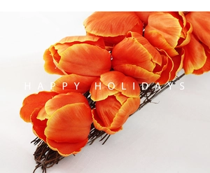 Detailed macro view of vibrant orange tulip petals on a carrot-shaped Easter door wreath