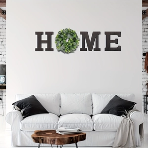 Modern black wooden HOME wall decor featuring a realistic green eucalyptus leaf wreath