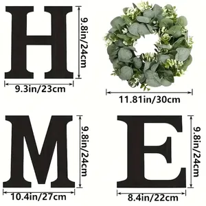 HOME wall decor set with black wooden letters H M E and eucalyptus wreath on white background